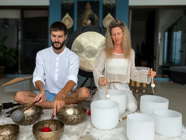 Max and Olha guiding a sound healing and Yoga Nidra workshop in their Koh Samui studio with singing bowls and gongs